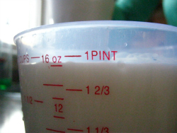 Milk in measuring cup closeup