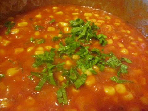 Adding Parsley to Corn and Tomato Sauce